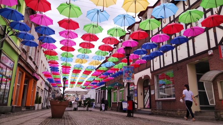 The colorful street of umbrellas in a Polish town delights tourists.  But that’s not the greatest treasure of this place